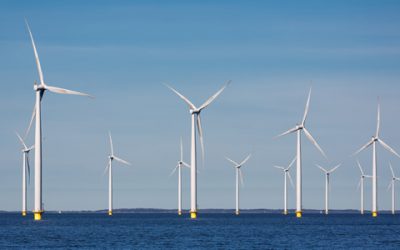 Offshore farm windturbines near Dutch coast against blue sky